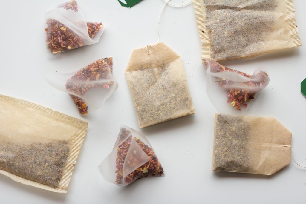 Different kinds of tea bags on a white background