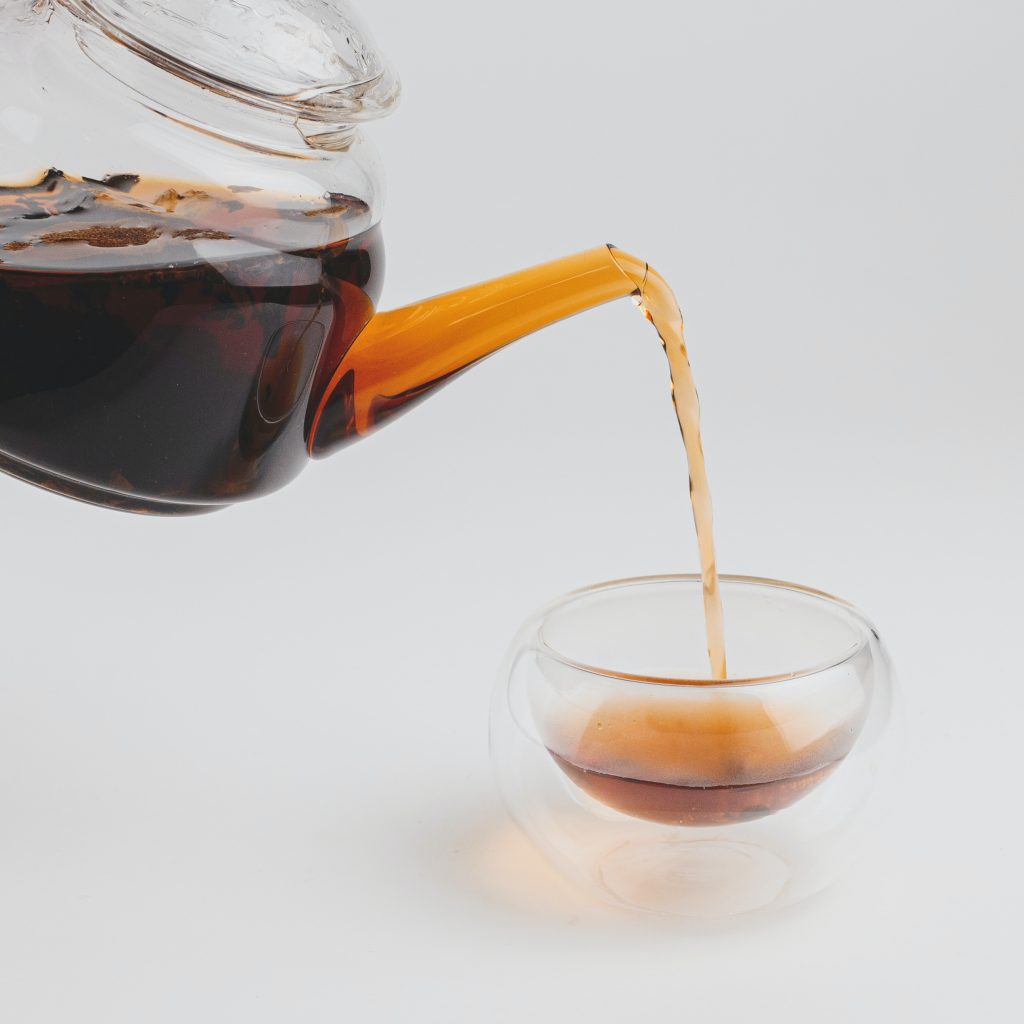 clear glass pitcher with black liquid